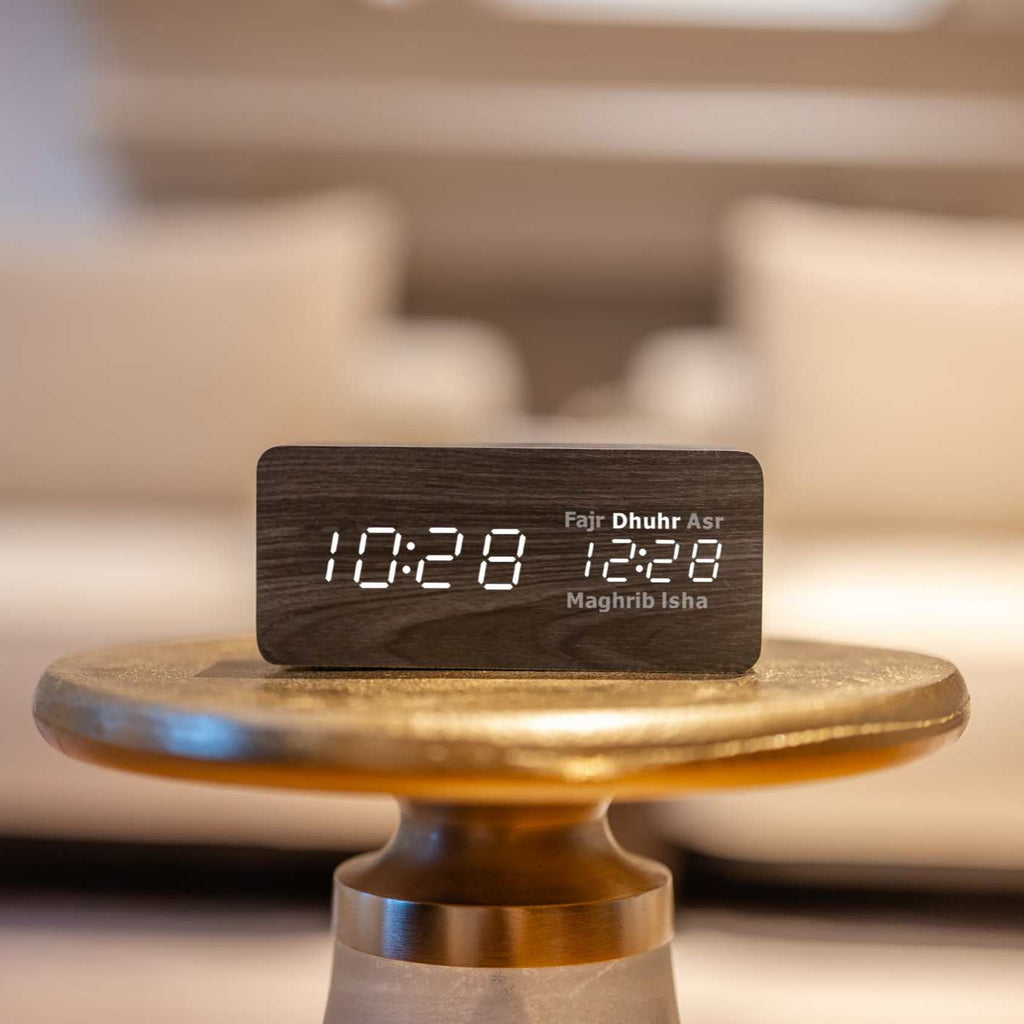 black smart athan clock on gold table