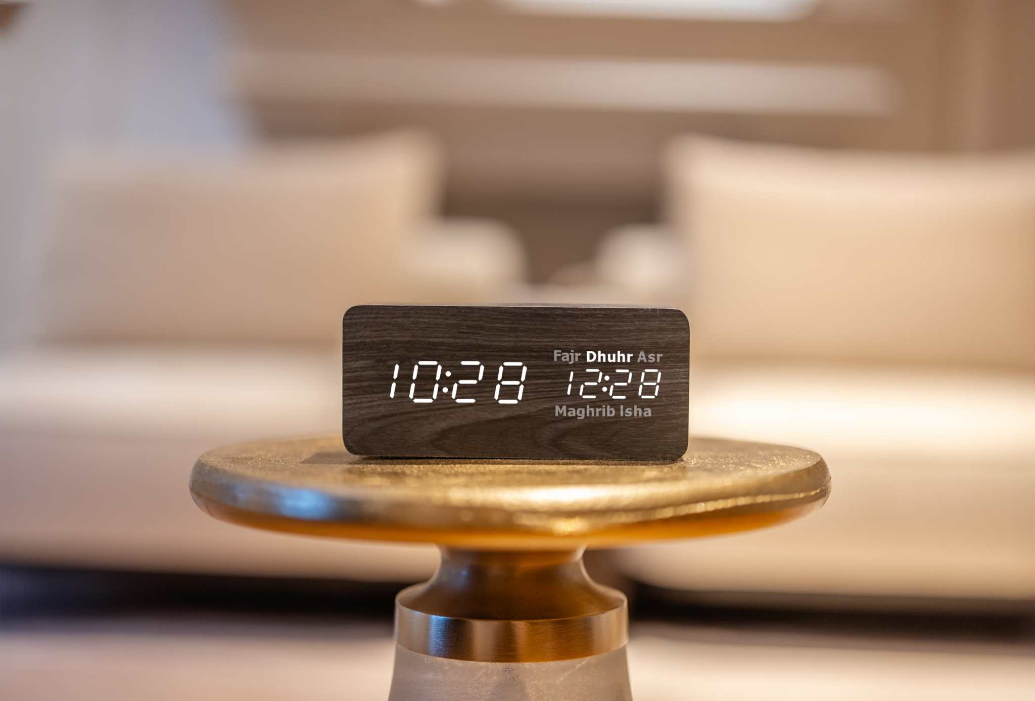 black smart athan clock on gold table
