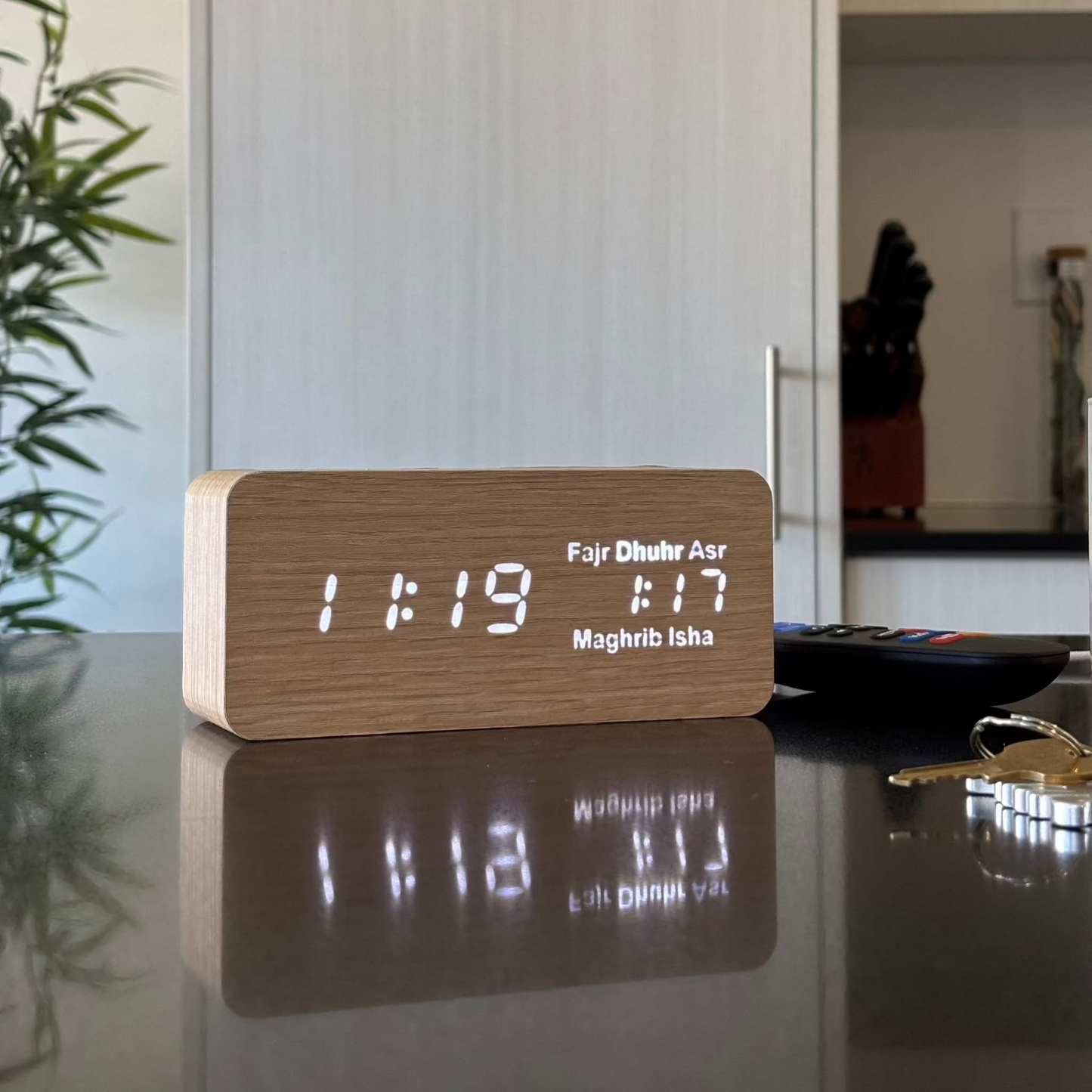 Modern athan clock placed on kitchen table top showing Dhuhr as the next prayer time at 1:17pm