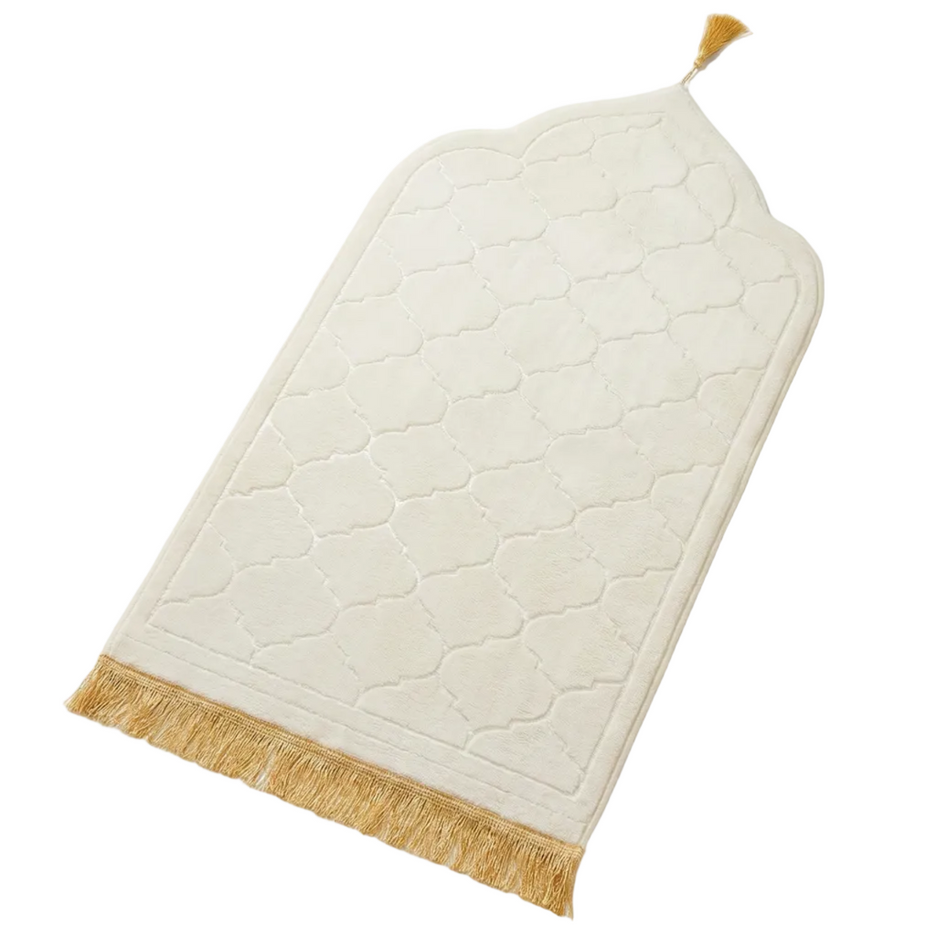 White textured towel with gold fringe on a white background