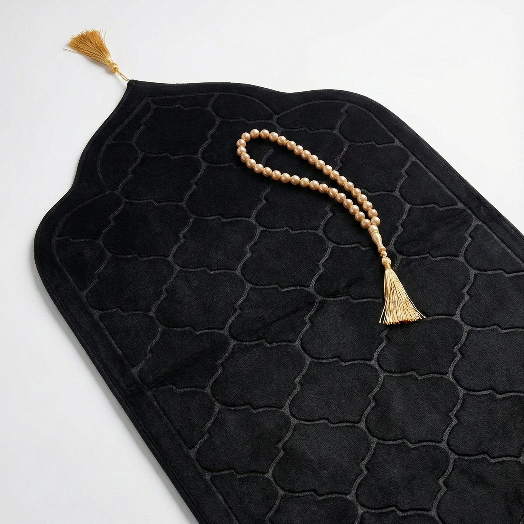 Black textured mat with tassels on a white background