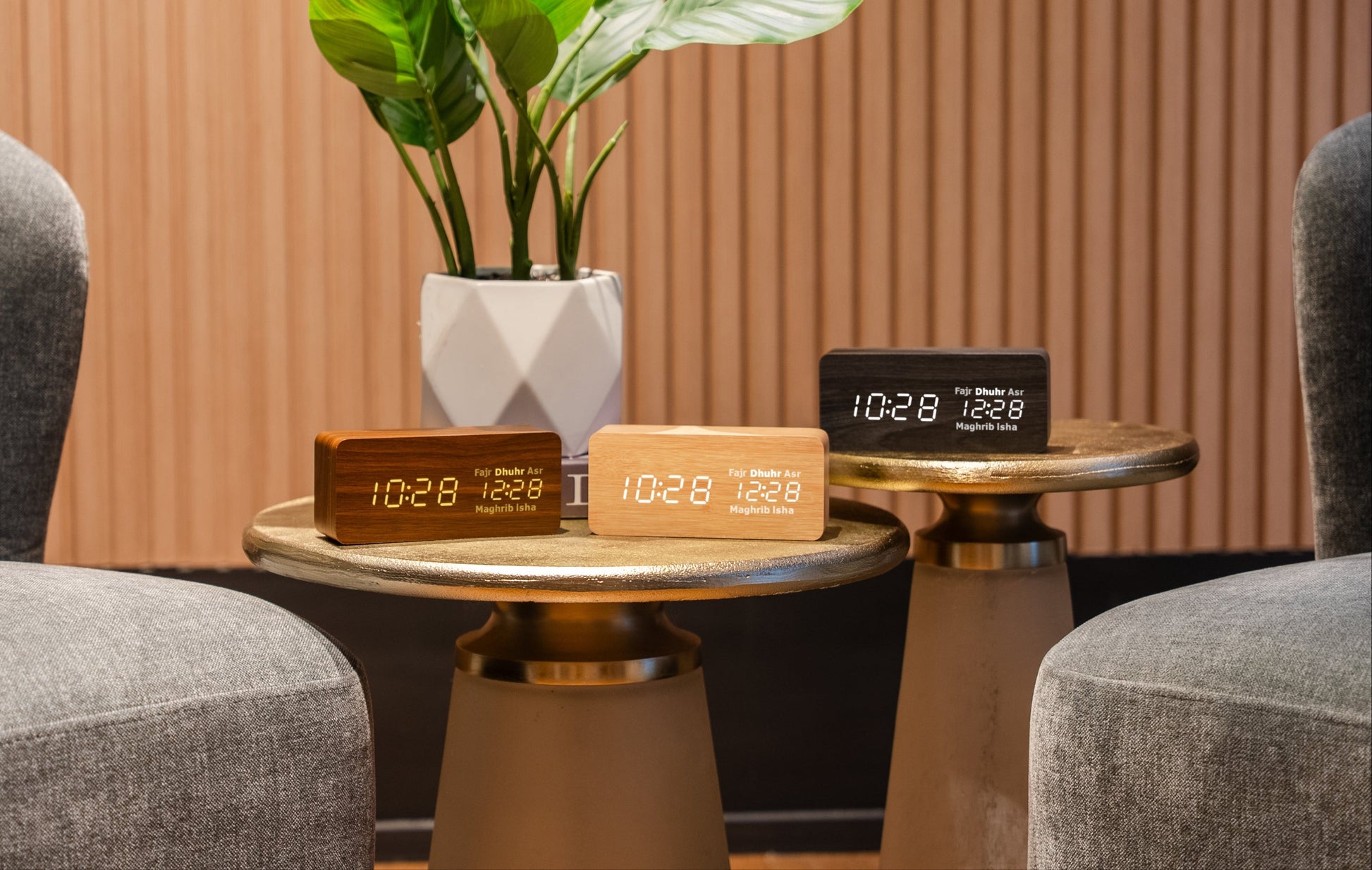 black, beige and brown athan clocks on gold tables
