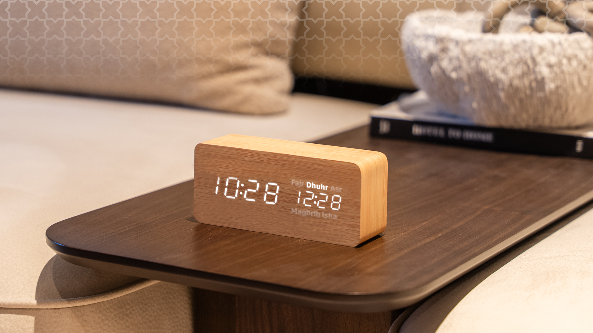 Adhan clock on a coffee table with a living room background