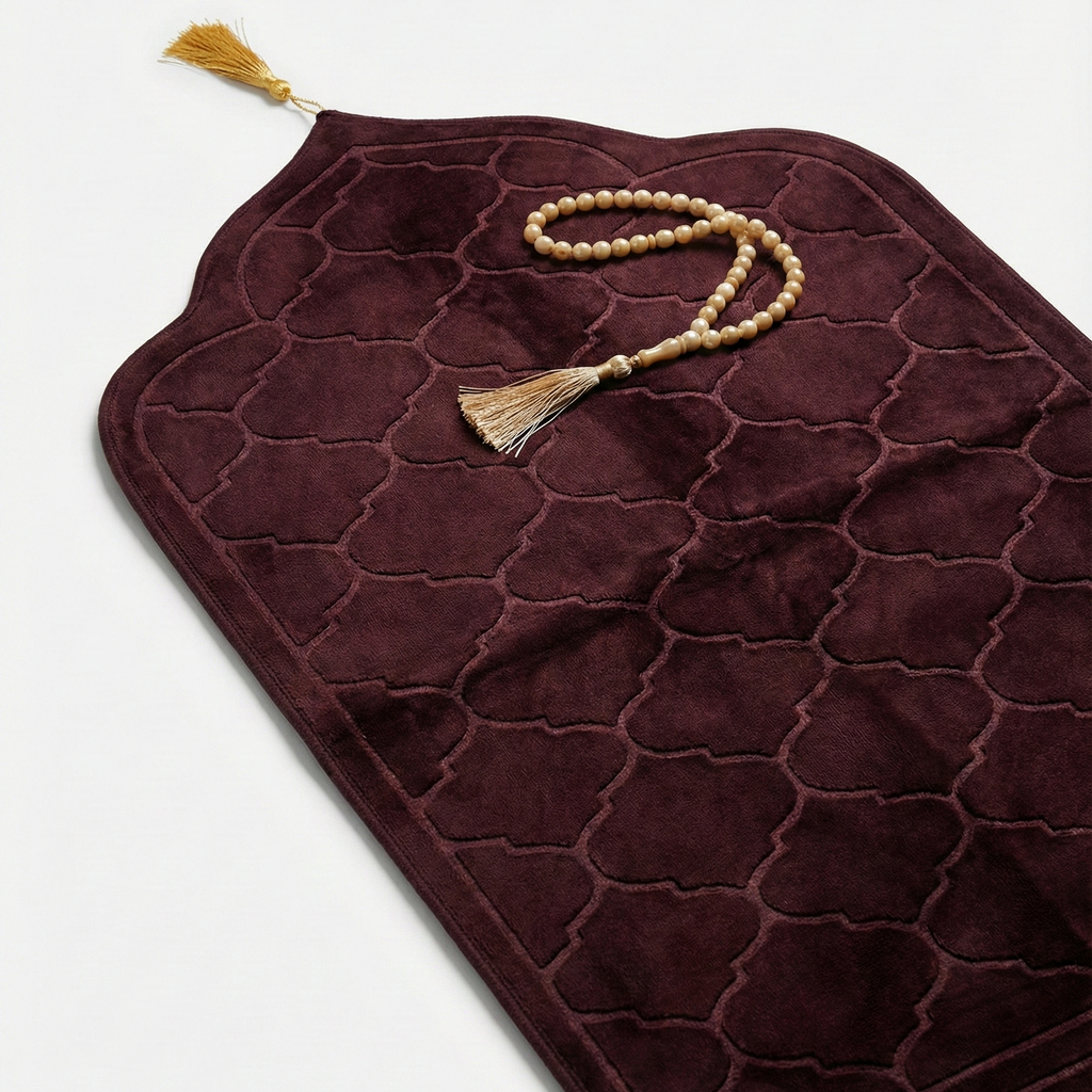 Brown prayer mat with a tassel on a light gray background