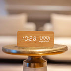 Beige smart athan clock on gold table showing dhuhr as next prayer time