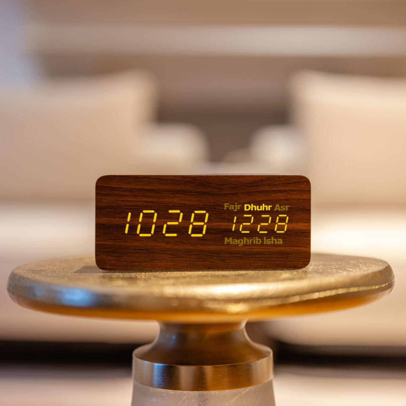brown smart athan clock on gold. table